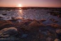 At sunset along the shores of the St Lawrence River in Quebec, the beautiful light dances across the low tide banks.