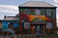 The exterior of Surf Lodge 45 is painted with murals and is situated in Opunake, Taranaki on the North Island of New Zealand.