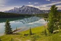 Fringed by lush forest and towering mountain peaks is Two Jack Lake, a peaceful and popular haven for nature lovers, which is situated in Banff National Park in the province of Alberta, Canada.