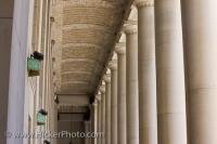 A row of columns stand straight and tall at the entrance to Union Station in downtown Toronto in Ontairo, Canada. When someone approaches the station, the first things they see are these straight stone columns.