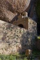 This unique building of ancient architecture located in the shadow of a huge rock, is the Monastery of San Juan de la Pena in the Sierra de la Pena in Aragon, Spain.