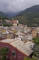 A view of the village of Vernazza in Liguria, Italy from Castello Doria which overlooks many of the buildings and the mountainsides.