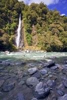 From a height of 28 metres, the Thunder Creek Falls plunge into the Haast River in Mt Aspiring National Park, New Zealand.