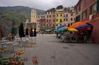 The colourful umbrellas of the waterfront cafes in the village of Vernazza in the Cinque Terre region of Liguria, Italy, in Europe.