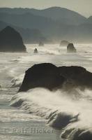 High towers of waves crashing into the rocks along Cannon Beach in Oregon, USA.