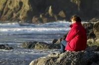 A woman enjoys a quiet moment during a vacation on the Olympic Peninsula in Washington, USA.