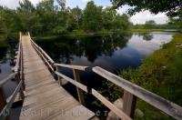 A wooden footbridge makes crossing the Mersey River in Kejimkujik National Park in Nova Scotia, Canada much easier than getting very wet and trying to swim.