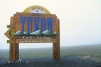 A brightly colored sign welcomes you to the Yukon after driving along the Dempster Highway.