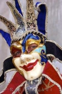 photo of Costumed Masked Character Grand Canal Venice Italy