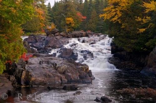 Photo of a river as it cascades over a waterfall in a Provincial Park in Quebec as the Autumn scenery highlights the trees. Photo: 
Autumn River Waterfall Scenery Quebec