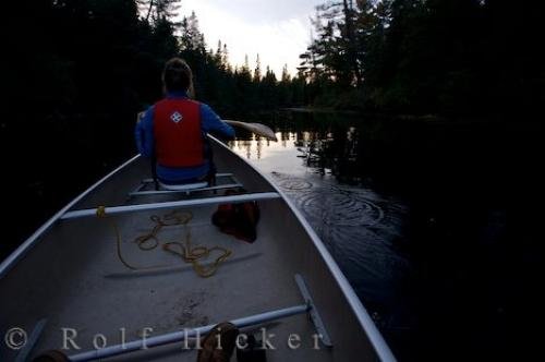 Photo of a woman canoeing along a river situated between two lakes in Algonquin Provincial Park in Ontario, Canada. Photo: 
Woman Canoeing Algonquin Provincial Park